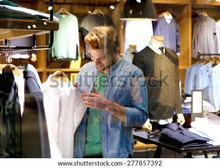 Portrait of a happy man shopping for clothes at clothing store