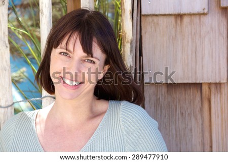 Close up portrait of a cheerful older woman smiling outside
