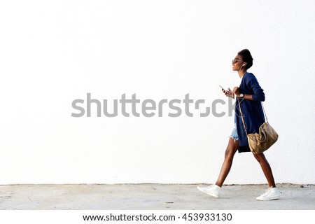 Similar – Image, Stock Photo Smiling black women walking along street together