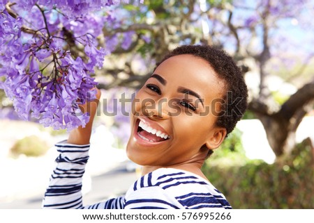 Similar – Image, Stock Photo Cheerful black woman smelling aromatic flower in hothouse