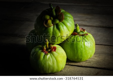 Still life garcinia atroviridis fresh fruit on old wood background. Thai herb and sour flavor lots of vitamin C for good health. Low key picture style. Extract as a weight loss product