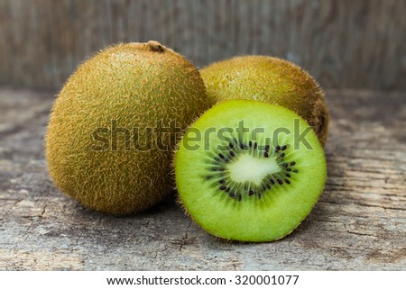 Close up fresh kiwi fruit on old wood background. Kiwi fruit is sweet and sour taste, nutritive value and high-fiber.