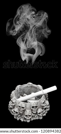 Ashtray decorated with human skulls and cigarette ends inside. Smoke with human skull appearing inside above the ashtray.