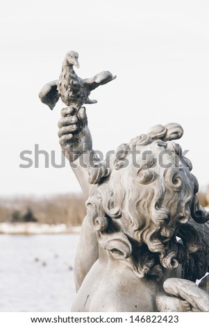 VERSAILLE, FRANCE - DECEMBER 30, 2012: Sculptures in the garden of the famous Versaille palace at a day before New Year\'s Eve on December 30, 2013 in Versaille, France