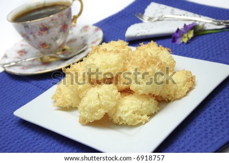 Coconut Macaroons on white plate, blue cloth, white background