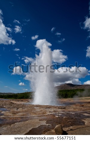 Icelands famous geyser Strokkur erupts. Nice shot at a sunny day against a blue sky.