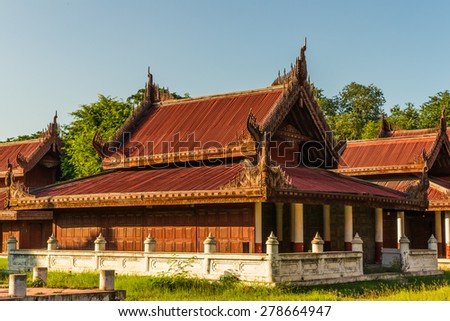 Well-preserved and/or reconstructed wooden buildings at the Mandalay Royal Palace compound seen at late afternoon sun