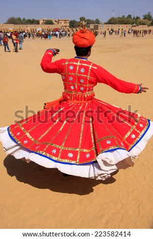 JAISALMER, INDIA - FEBRUARY 16: Unidentified man dances during Desert Festival on February 16, 2011 in Jaisalmer, India. Main purpose of Festival is to display rich and colorful culture of Rajasthan