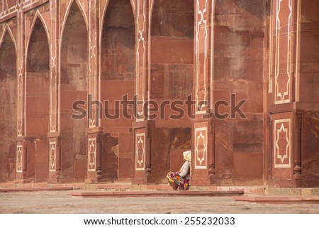 Indian woman sitting outside Humayun\'s Tomb, Delhi, India. It was the first garden-tomb on the Indian subcontinent.