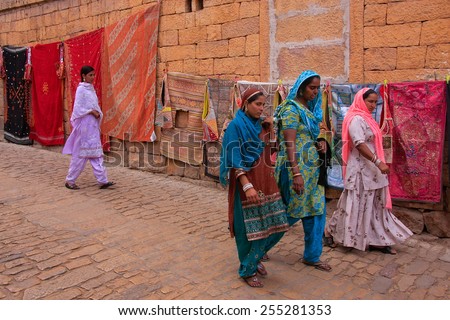 JAISALMER, INDIA - FEBRUARY 17: Unidentified women walk in Jaislamer fort on February 17, 2011 in Jaisalmer, India. Jaisalmer is called Golden City because of sandstone used in its architecture