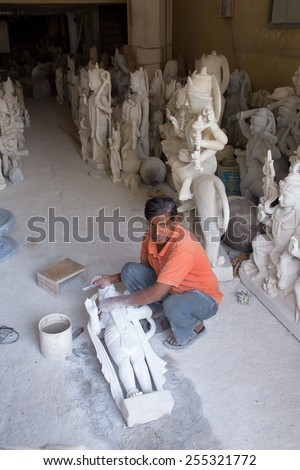 DELHI, INDIA - NOVEMBER 5: Unidentified man works  on a statue at a workshop on November 5, 2014 in Delhi, India. Delhi is the second most populous city in India.