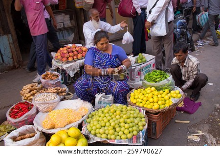 DELHI, INDIA-NOVEMBER 5: Unidentified woman sells fruits on November 5, 2014 in Delhi, India. Street vendors provide local people with fresh and cheap produce and are widly spread through out the city