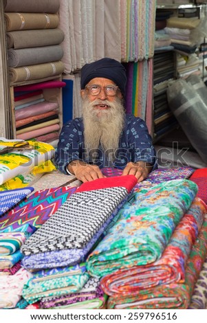 DELHI, INDIA - NOVEMBER 5: Unidentified man sells textile at Chandni Chowk on November 5, 2014 in Delhi, India. Chandni Chowk is one of the oldest and busiest markets in Old Delhi.