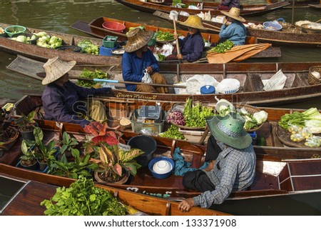 BANGKOK APRIL 13: Wooden boats busy ferrying people at Amphawa floating market on April 13, 2011 in Bangkok.