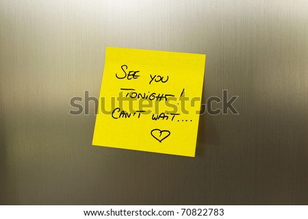 Yellow love note on metal fridge