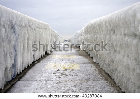 Hand rails coated with winter ice from Lake Michigan form a cold vanishing point linear prospective