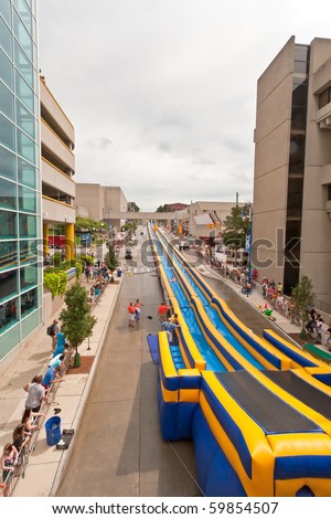 GRAND RAPIDS, MI- AUG 21: Lyon Street is transformed into a waterpark with a 500-foot water slide, said to be the world\'s longest, installed by Rob Bliss Events on Aug 21, 2010 in Grand Rapids, MI.