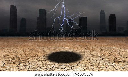 Dark city with hole in desert floor