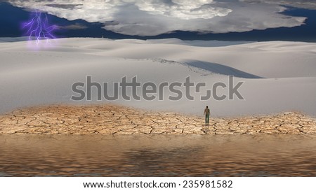 Man stands before vast desert landscape