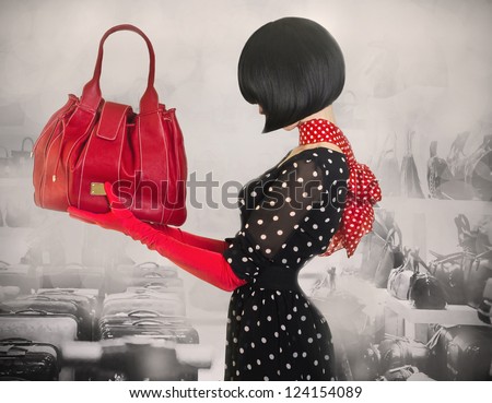 Art photo elegant lady with stylish short hairstyle holding a bag.