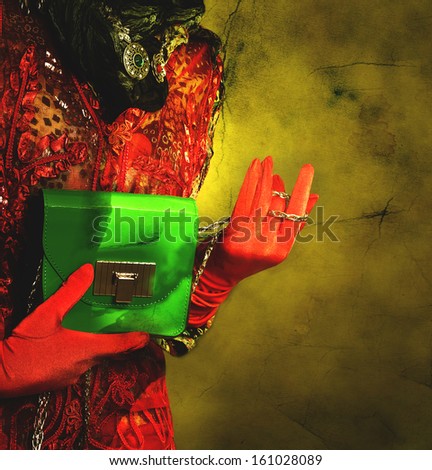 Elegant lady in gloves holding a bag