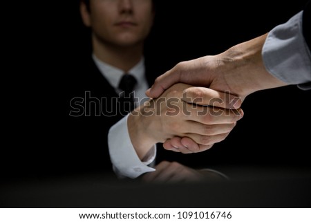 Anonymous business partners making handshake in dark shadow Stok fotoğraf © 