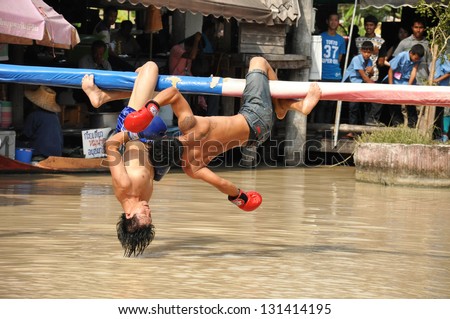 PATTAYA, THAILAND - MAR. 2 :traditional water Thai boxing (or Muay Talay) - ancient Thai fight above the water - at Pattaya floating market, Thailand  on Mar 2, 2013.