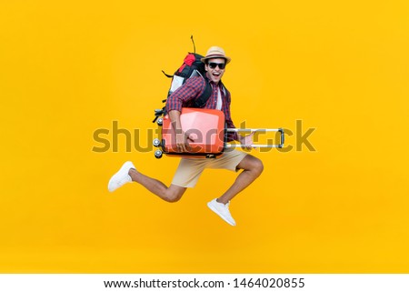 Image, Stock Photo Asian man with travel bag using smartphone against white wall