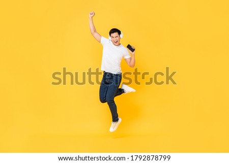 Similar – Image, Stock Photo Young Man with Earphones Posing in Autumn Park