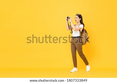 Similar – Image, Stock Photo Happy tourist woman taking pictures of the old town with a retro camera
