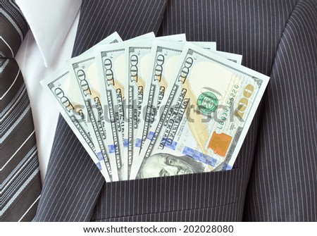 Money - United States dollar (or USD) banknotes in suit pocket