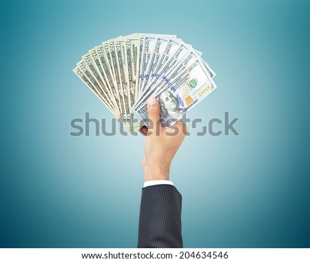 Hand holding money - United states dollar (USD) banknotes