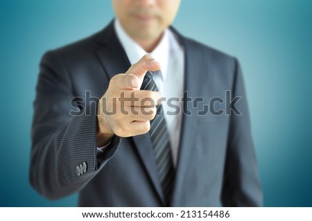 Businessman pointing finger at you