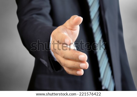 Businessman hand reaching out offering handshake