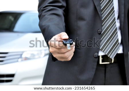 Businessman giving a car key - car sale & rental concept