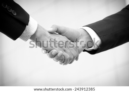 Handshake of businessmen, greeting, dealing, partnership, merger & acquisition concepts - monochrome effect