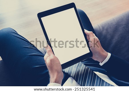 Businessman hands holding tablet pc with isolated screen - vintage & retro style color effect