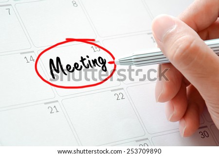 Meeting text on the calendar (or desk planner) circled with red marker