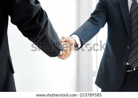 Handshake of businessmen; success, dealing, greeting & business partner concepts - soft focus
