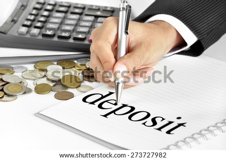 Hand with pen pointing to deposit word on the paper