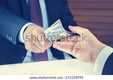 Hand receiving money from businessman - vintage tone