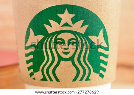 Bangkok, Thailand - May 06, 2015 : Starbucks brand logo on coffee cup sleeve, Starbucks is one of the most world famous coffeehouse chains from USA