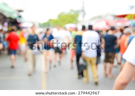 Blurred crowd walking on the street, outdoor market - can be used as abstract blur background