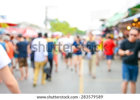 Blurred crowd walking on the street, outdoor market - can be used as abstract blur background