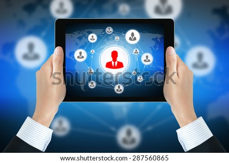 Businessman hands holding tablet pc with businesspeople icons linked as network on the screen - online business & social network concepts