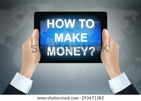 HOW TO MAKE MONEY  text on tablet pc screen held by businessman hands