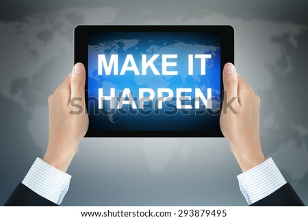 MAKE IT HAPPEN text on tablet pc screen held by businessman hands