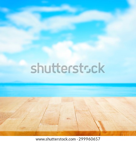 Wood table top on blur sea and summer sky background - can be used for display and montage your products