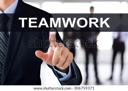 Businessman hand touching TEAMWORK sign on virtual screen