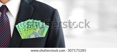 Money,Australian dollar (AUD) banknotes, in businessman suit pocket - financial and investment panoramic background with copy space